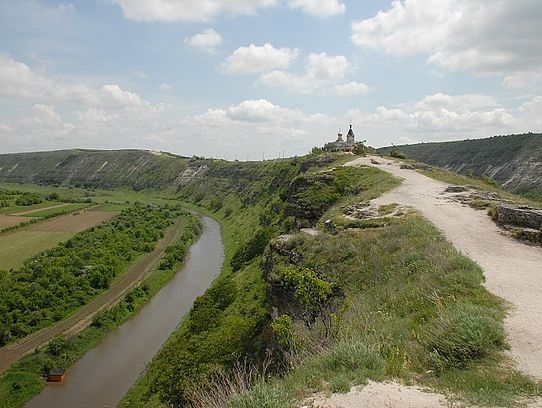 river with hill and church